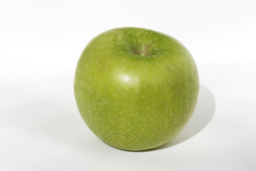 green apple lies on a white background