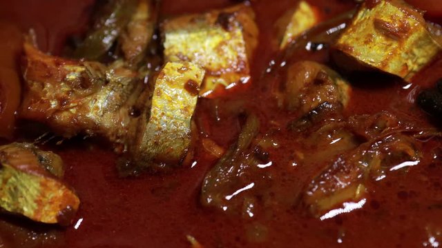 Meen Vattichathu or Pattichathu, sardine fish cooked. Traditional hot and spicy fish curry Kerala India with dried red chilly and green curry leafs. Very popular coastal food eat with tapioca or rice