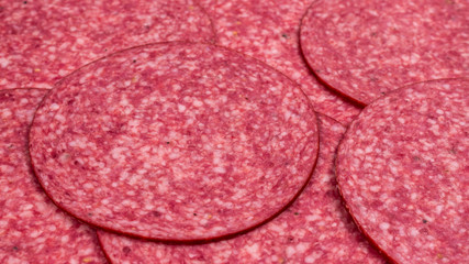 Tasty salami slices background.