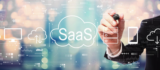 SaaS - software as a service concept with businessman on blurred abstract background