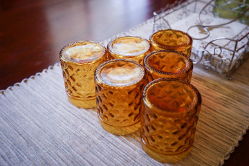 Vintage amber glasses stacked upside down in cafe setting 