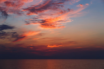 Naklejka na ściany i meble A stunning pink and orange sunset sky in the middle of Mediterranean sea, sunset background.