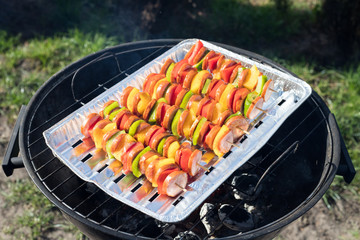 Colorful skewers of sausage on the grill on a sunny day, the concept of grilling, top view