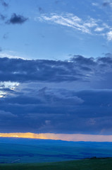 Fototapeta premium Rain clouds over distant hills at sunset. Zabaykalsky Krai. Russia.