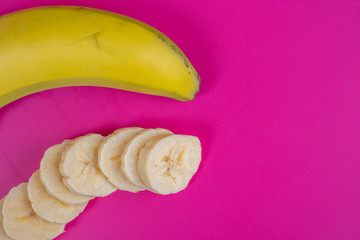 banana with slices in front on background