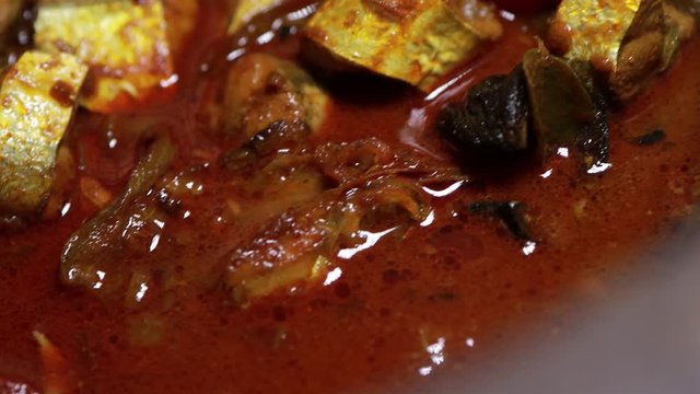 Meen Vattichathu or Pattichathu, sardine fish cooked. Traditional hot and spicy fish curry Kerala India with dried red chilly and green curry leafs. Very popular coastal food eat with tapioca or rice