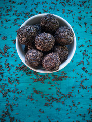 Brigadeiro.Traditional Brazilian sweet. Blue background with scattered chocolate sprinkles