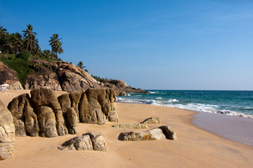 Fototapeta na wymiar seashore with palm trees and big stones. India. Kerala.
