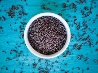 Granulated chocolate brigadeiro in white bowl. Blue background