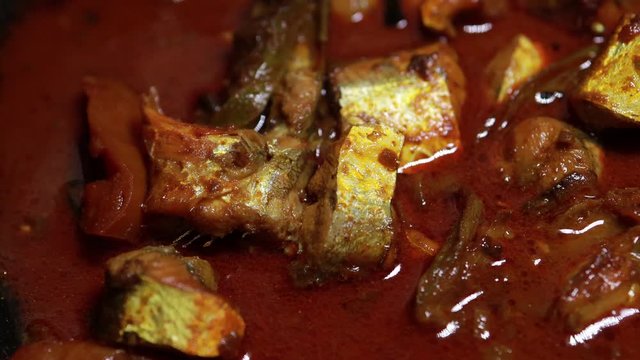 Meen Vattichathu or Pattichathu, sardine fish cooked. Traditional hot and spicy fish curry Kerala India with dried red chilly and green curry leafs. Very popular coastal food eat with tapioca or rice