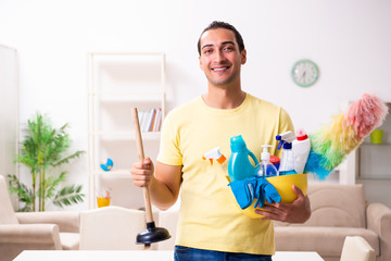 Young male contractor doing housework at home