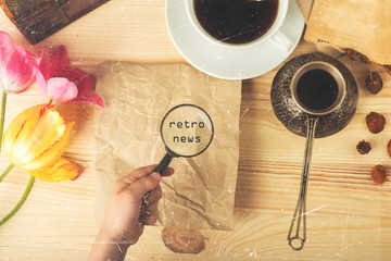 reading news, viewing and reading retro news, a table with retro objects and a magnifying glass