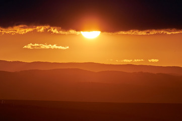 Rain over the distant hills at sunset. Zabaykalsky Krai. Russia.