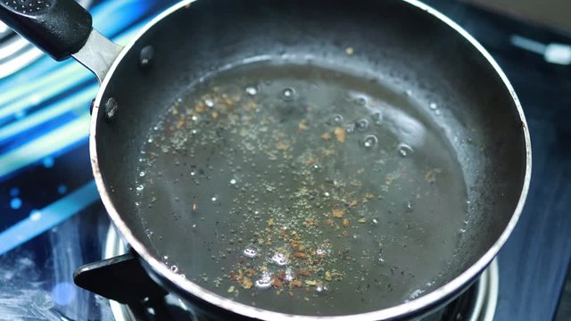 Boiling cocunut oil in pan is cooking