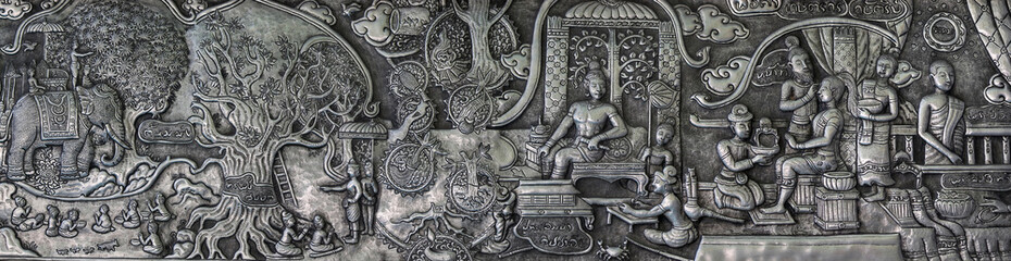 Aluminium and silver bas-relief with stories of Buddhism, dharma puzzles, and the history of the Wat Sri Suphan, Silver temple in Chiang Mai, Thailand