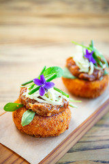 Breaded and deep fried meatball with sauce on top