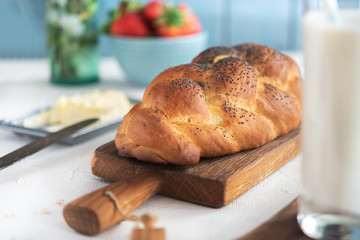 Fresh challah bread for breakfast on rural background