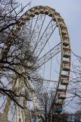 Nice ferris wheel of Budapest from below and among the trees.