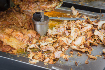 Pile of slices doner kebab meat being thin shavings from a rotating rotisserie spin in Singapore