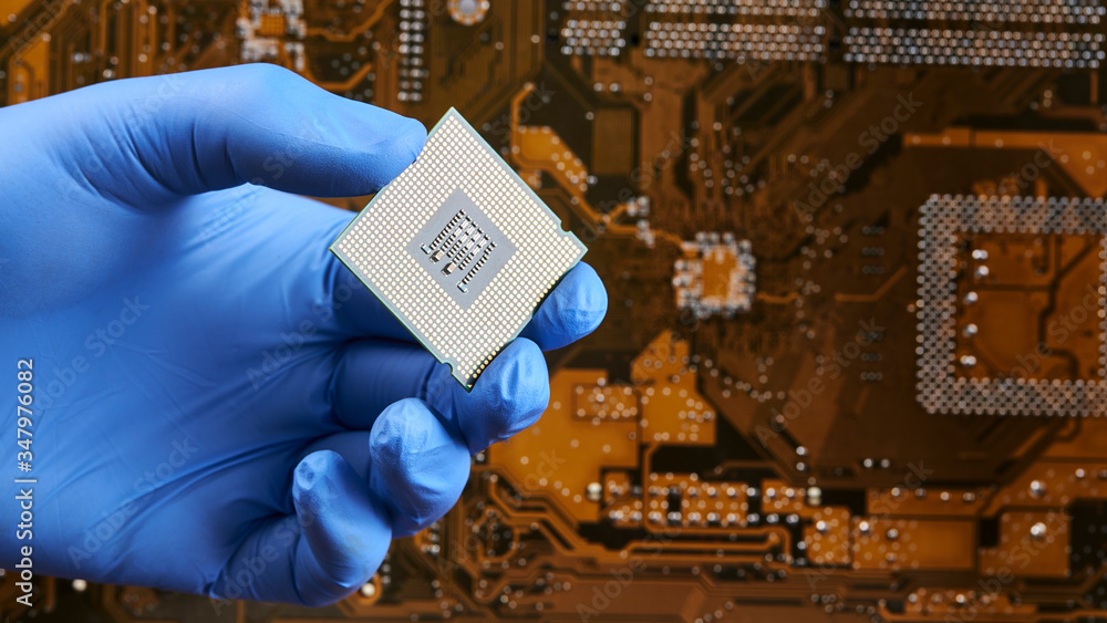 Poster engineer person holds cpu central processor unit over circuit board background. hardware research co