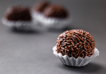 Brigadeiro (Brigadier) a Brazilian chocolate candy. Traditional Brazilian handmade chocolate sweet on dark background