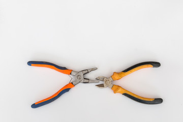 Obraz premium Wire cutters and pliers with orange black handles on white background