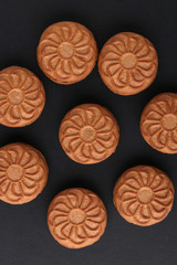 Plate with brown cookies on old Black Stone table. Top view