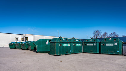 Large public recycling station at parking lot for disposal of different household waste - plastic,...
