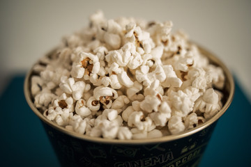 popcorn in an iron can. Watching a movie. TV shows. Watch TV shows. Watch a movie. Good company. Watching a movie. Blue background