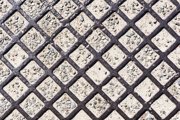 Metal mesh texture. Grunge sewer grate background. Steel street manhole lid pattern.