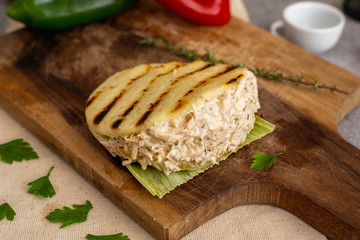 Chicken arepa with on wooden board (Colombian and Venezuelan typical food)