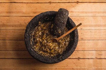 Green sauce of green tomatoes, serrano chile, onion, salt and lemon, served in a molcajete, with a...