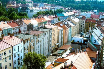 Fototapeta premium Ancient houses, street and many green trees top view