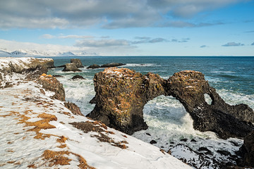 Gatklettur arch in the ocean in Arnarstapi village, Iceland