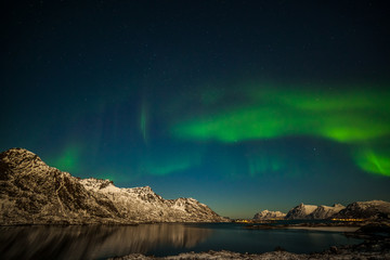 Nature of Norway. Aurora Borealis in Tromso, Norway in front of the Norwegian fjord, winter season, long shutter speed.