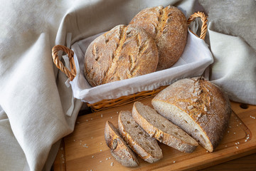 Loaf of french domestic bread on wooden table