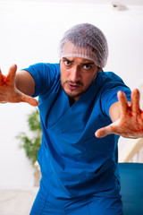 Young male doctor surgeon in fatal negligence concept