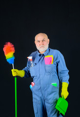 Cleaning time. Old man with cleaning equipment. Professional cleaning. Clean up. Clearing tools. Broom. House cleaning. In full height. Broom. Dust brush. Household. Housekeeping.