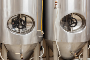 Brewery, two beer tanks, cylinder-conical fermentation tanks in drops of water