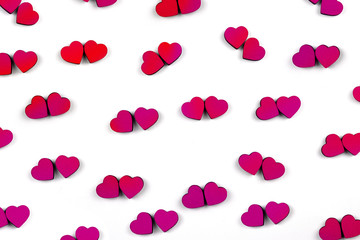 Pattern of a lot of small red and pink hearts isolated on white background. Hearts are located by couples. Concept of love. Flat lay.
