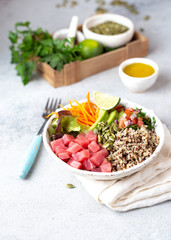 Healthy raw tuna bowl with quinoa and vegetales. Buddha bowl