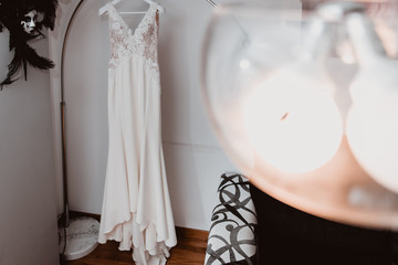 white wedding dress hanging on the hanger