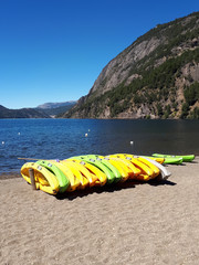 group of colorful kayaks at the beach