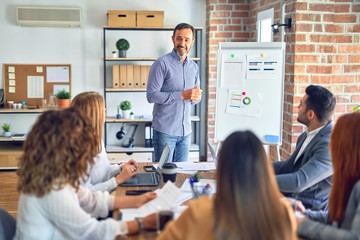 Group of business workers working together in a meeting. One of them making presentation to...