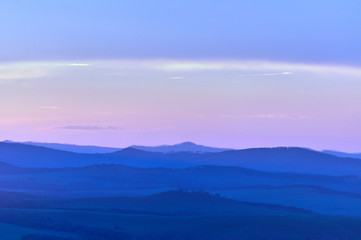 Distant hills over the steppe at sunset. Zabaykalsky Krai. Russia.