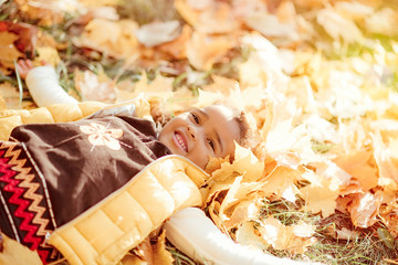 happy little child, baby girl laughing and playing in the autumn on the nature walk outdoors.
