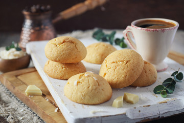 Coconut cookies with white chocolate and  cup of coffee