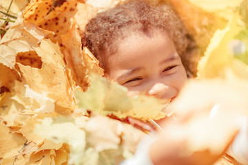 happy little child, baby girl laughing and playing in the autumn on the nature walk outdoors.