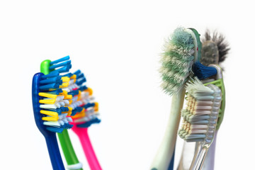 Confrontation, used toothbrushes and new toothbrushes on a white background - 348005029