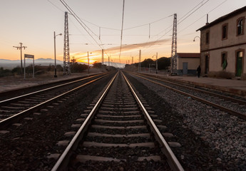Fototapeta na wymiar sunset on the train tracks in Avila, Spain